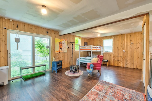 15951 Water St, Garden, MI 49835 - bedroom with wood walls, wood-type flooring, beamed ceiling, and a wood stove