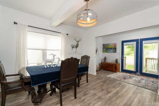 15951 Water St, Garden, MI 49835 - dining space featuring a chandelier, beamed ceiling, light wood-style floors, and french doors