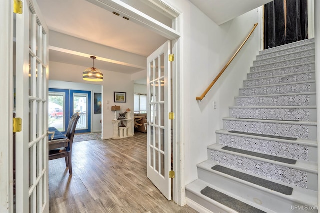 15951 Water St, Garden, MI 49835 - entrance foyer featuring french doors, stairs, and light wood finished floors