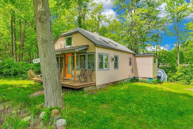 7416 Forest Rd, Lexington, MI 48450 - view of front of home featuring a wooden deck and a front lawn