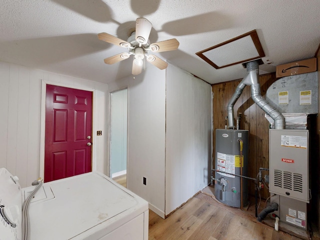 13148 Saginaw Rd, Clio, MI 48420 - utility room with gas water heater, washer / dryer, and heating unit