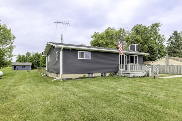 4856 Wagner Rd, Croswell, MI 48422 - rear view of property with a wooden deck, a chimney, and a lawn
