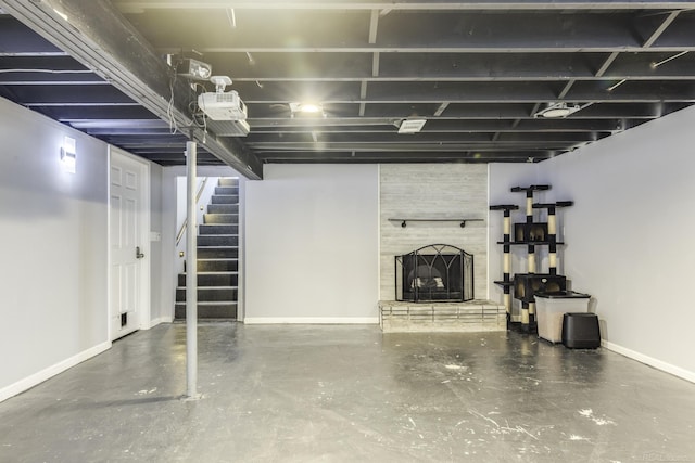 4856 Wagner Rd, Croswell, MI 48422 - finished basement with a large fireplace and stairs