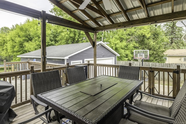 4856 Wagner Rd, Croswell, MI 48422 - deck with outdoor dining area, an outbuilding, a grill, and view of wooded area