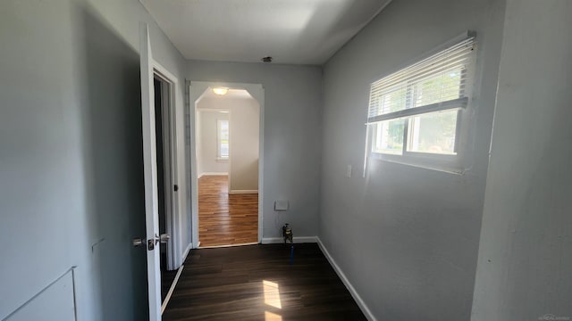 11444 Cadillac St, Warren, MI 48089 - corridor featuring dark wood finished floors, arched walkways, and healthy amount of natural light