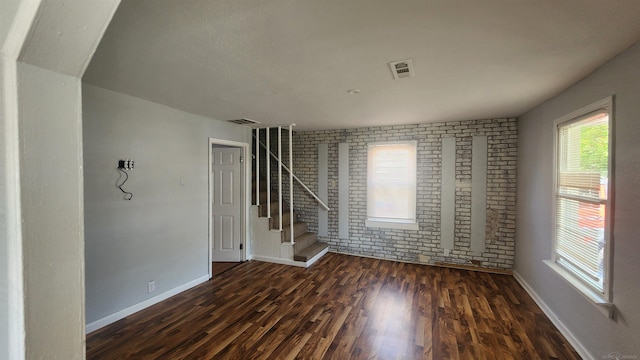 11444 Cadillac St, Warren, MI 48089 - unfurnished room with brick wall, wood finished floors, and stairs
