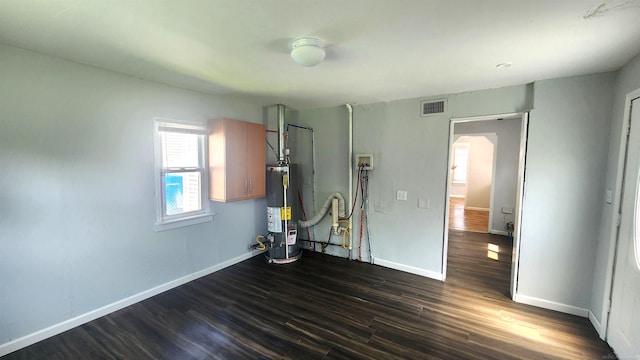 11444 Cadillac St, Warren, MI 48089 - unfurnished bedroom featuring gas water heater, arched walkways, and dark wood finished floors