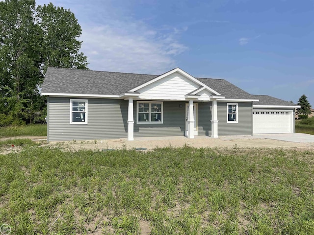8540 Wildcat Rd, Jeddo, MI 48032 - ranch-style house featuring a shingled roof, concrete driveway, a porch, and a garage