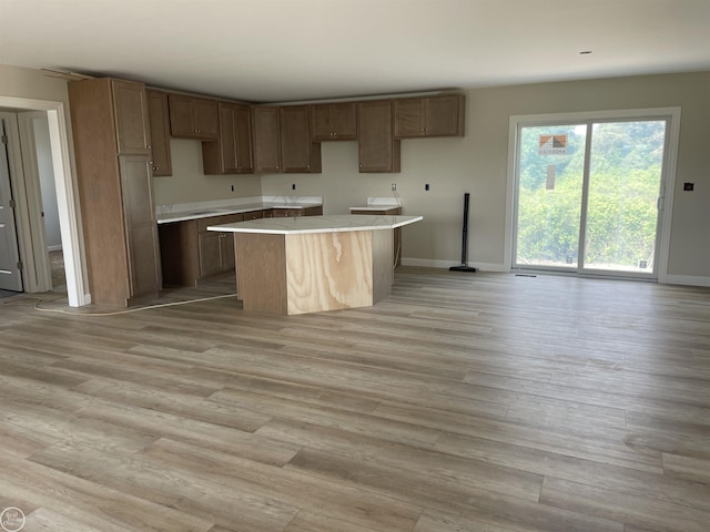 8540 Wildcat Rd, Jeddo, MI 48032 - kitchen with a center island, light wood-type flooring, and light countertops