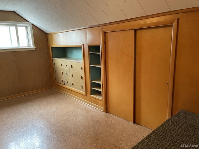 301 N 7th Ave, Hurley, WI 54534 - unfurnished bedroom with a closet, vaulted ceiling, and wood walls