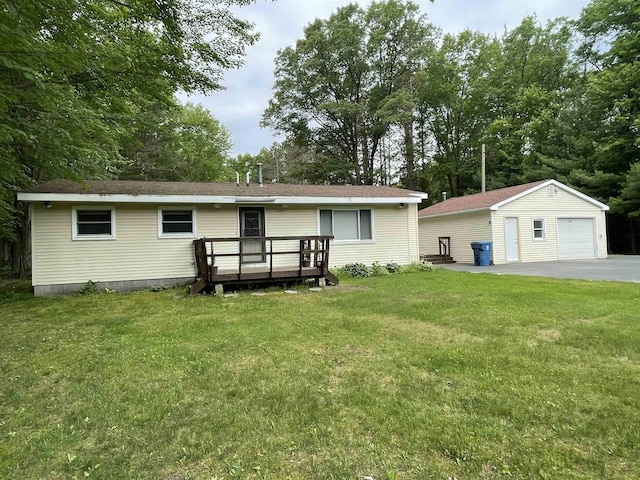 1549 N 7 Mile Rd, Sanford, MI 48657 - back of property with a garage, an outbuilding, a yard, a wooden deck, and asphalt driveway