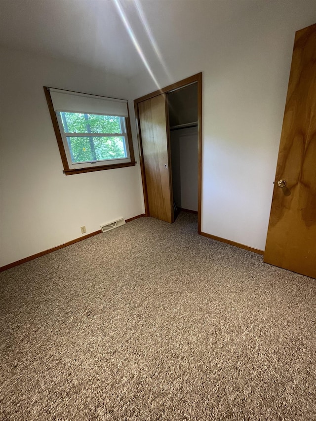 1549 N 7 Mile Rd, Sanford, MI 48657 - unfurnished bedroom featuring a closet and carpet floors