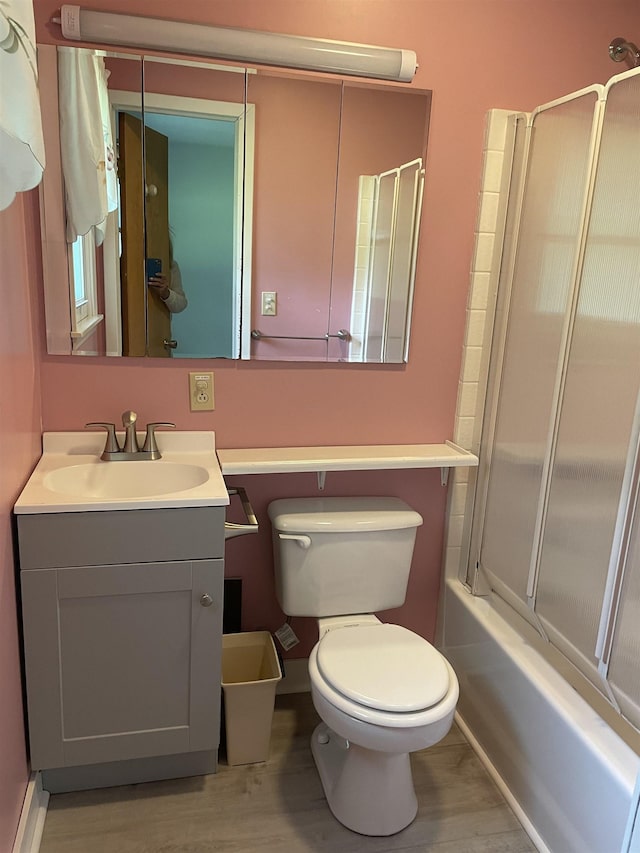 1549 N 7 Mile Rd, Sanford, MI 48657 - bathroom featuring vanity, wood finished floors, and combined bath / shower with glass door