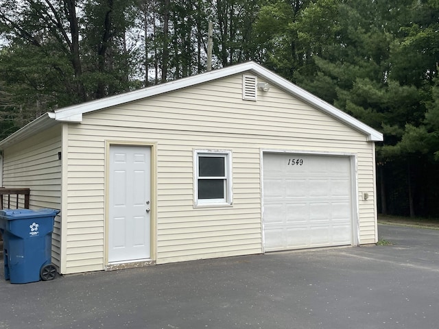 1549 N 7 Mile Rd, Sanford, MI 48657 - detached garage with driveway and view of scattered trees