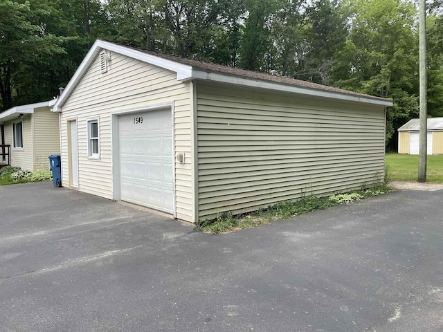 1549 N 7 Mile Rd, Sanford, MI 48657 - detached garage featuring view of wooded area