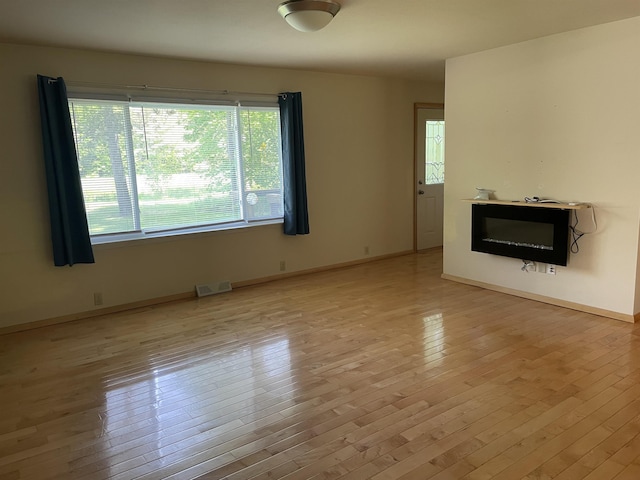 1549 N 7 Mile Rd, Sanford, MI 48657 - unfurnished living room featuring hardwood / wood-style flooring
