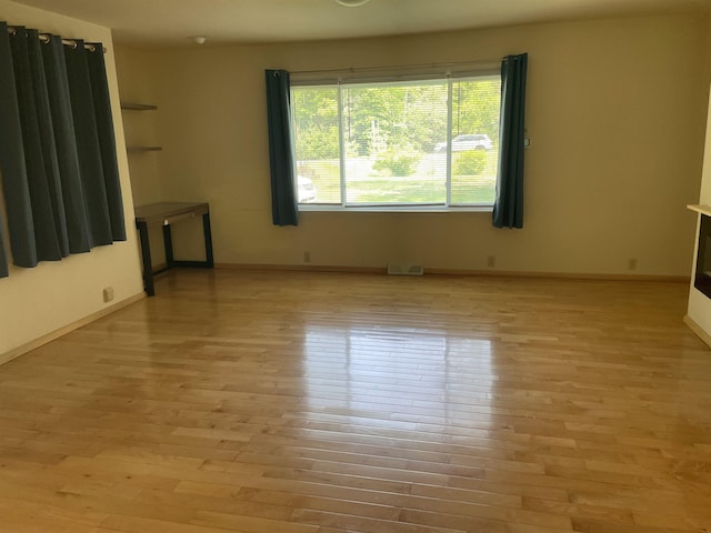 1549 N 7 Mile Rd, Sanford, MI 48657 - spare room with light wood-style flooring and baseboards