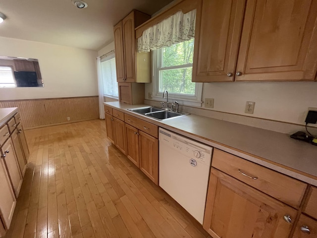 1549 N 7 Mile Rd, Sanford, MI 48657 - kitchen with dishwasher, light wood-style floors, wainscoting, wooden walls, and light countertops