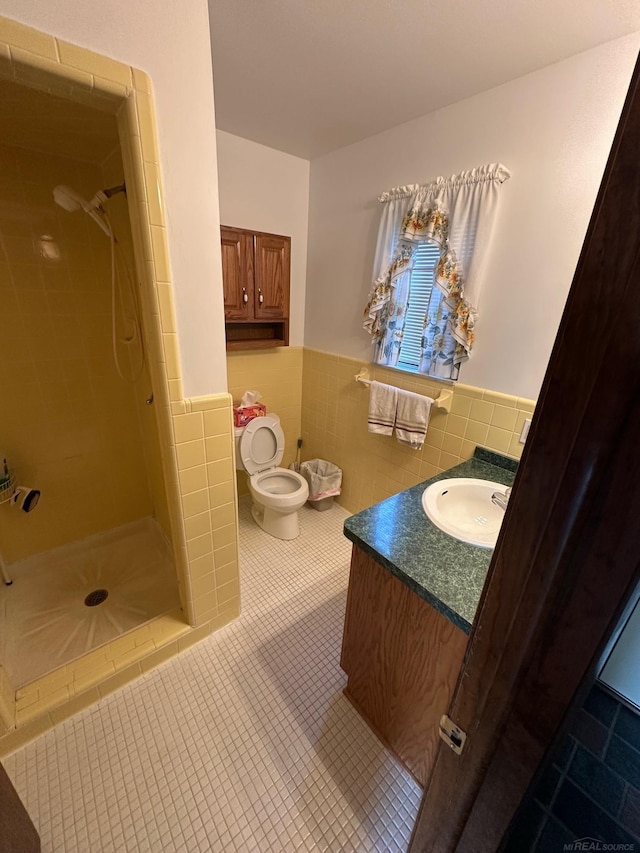 8856 Balboa Ave, Sterling Heights, MI 48313 - full bath with a wainscoted wall, tile walls, vanity, a stall shower, and tile patterned floors