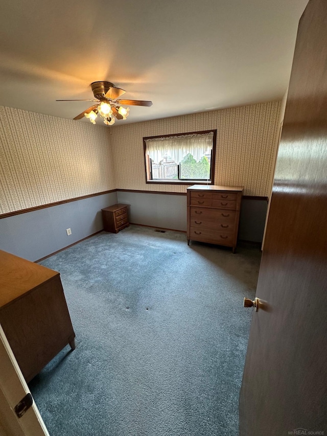 8856 Balboa Ave, Sterling Heights, MI 48313 - unfurnished bedroom featuring wallpapered walls, carpet floors, and a ceiling fan