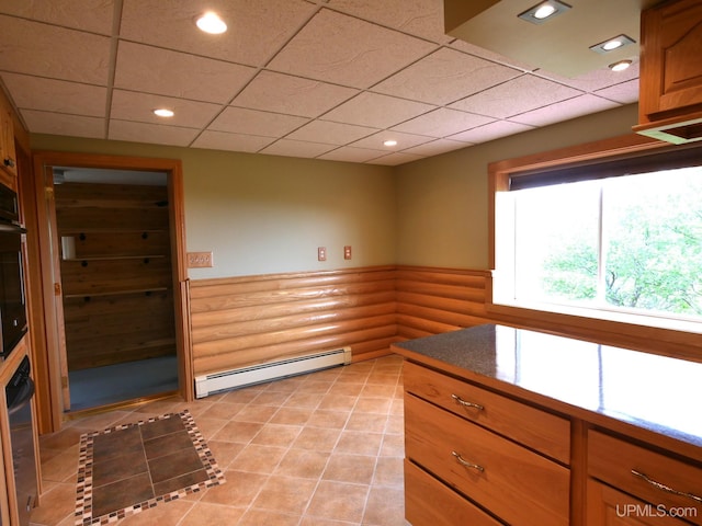 1120 Dextrom Rd, Calumet, MI 49913 - kitchen featuring a baseboard radiator, wainscoting, recessed lighting, a paneled ceiling, and light tile patterned flooring