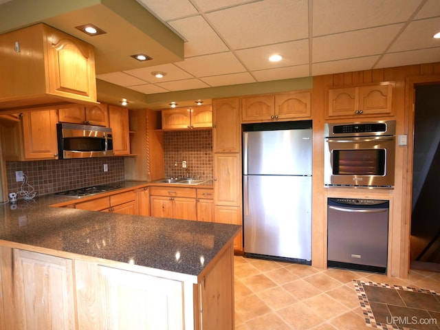 1120 Dextrom Rd, Calumet, MI 49913 - kitchen with stainless steel appliances, a peninsula, decorative backsplash, light tile patterned floors, and a drop ceiling