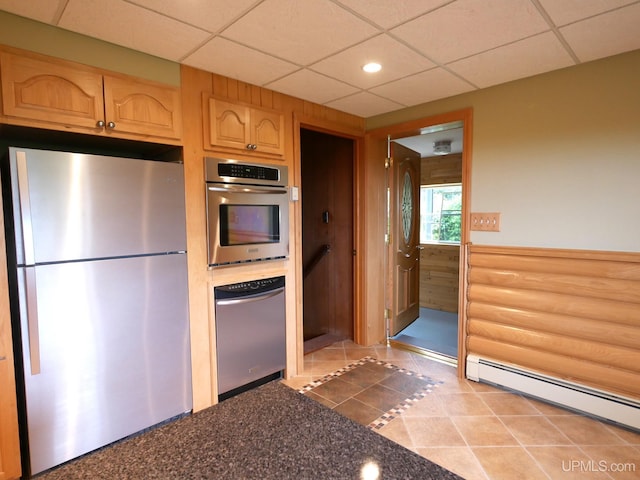 1120 Dextrom Rd, Calumet, MI 49913 - kitchen with stainless steel appliances, a baseboard radiator, a paneled ceiling, light brown cabinetry, and dark countertops