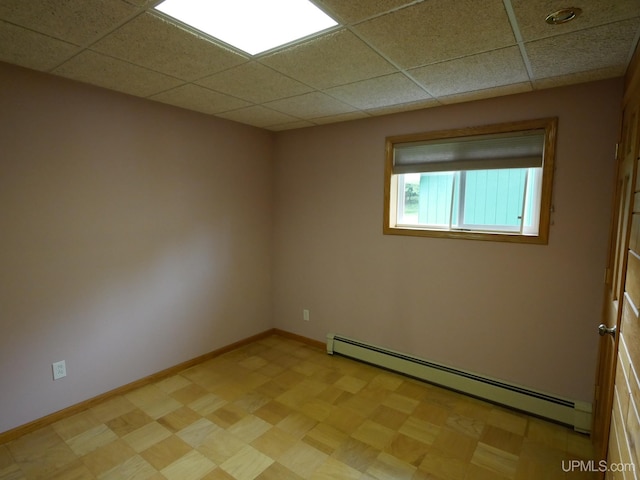 1120 Dextrom Rd, Calumet, MI 49913 - empty room with baseboard heating and a drop ceiling
