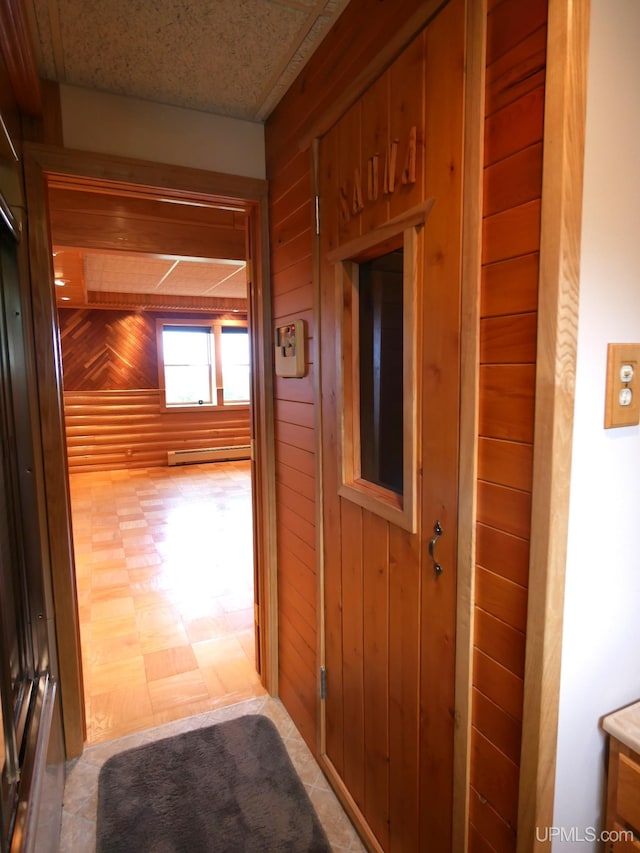 1120 Dextrom Rd, Calumet, MI 49913 - hallway with wood walls and a baseboard heating unit