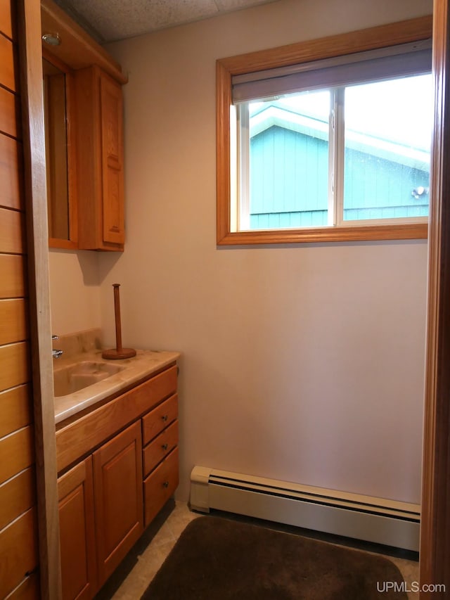 1120 Dextrom Rd, Calumet, MI 49913 - bathroom with a baseboard heating unit, vanity, and tile patterned flooring