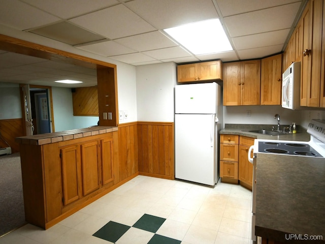 1120 Dextrom Rd, Calumet, MI 49913 - kitchen with white appliances, wainscoting, brown cabinets, a peninsula, and a drop ceiling