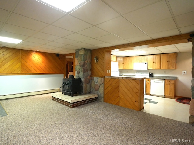 1120 Dextrom Rd, Calumet, MI 49913 - kitchen with white appliances, a paneled ceiling, a wood stove, wooden walls, and a baseboard radiator