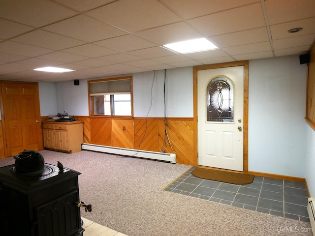 1120 Dextrom Rd, Calumet, MI 49913 - basement with baseboard heating, a wainscoted wall, wood walls, and a paneled ceiling