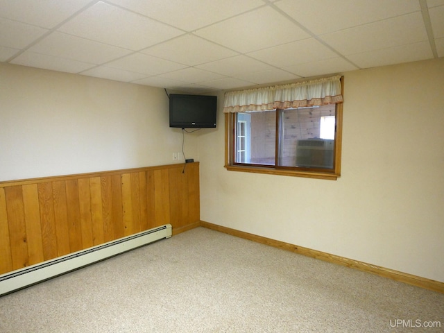 1120 Dextrom Rd, Calumet, MI 49913 - unfurnished room with a baseboard heating unit, a drop ceiling, carpet flooring, cooling unit, and wooden walls