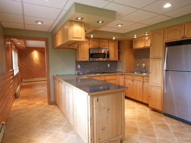 1120 Dextrom Rd, Calumet, MI 49913 - kitchen featuring appliances with stainless steel finishes, a paneled ceiling, a peninsula, a baseboard heating unit, and tasteful backsplash
