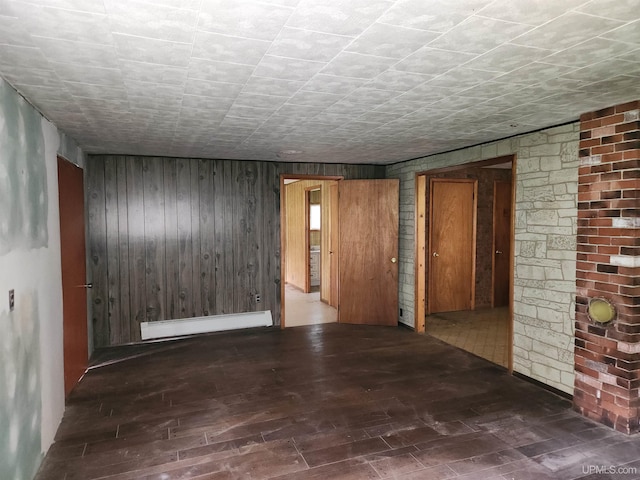 1120 Dextrom Rd, Calumet, MI 49913 - empty room featuring baseboard heating, wood finished floors, and wood walls