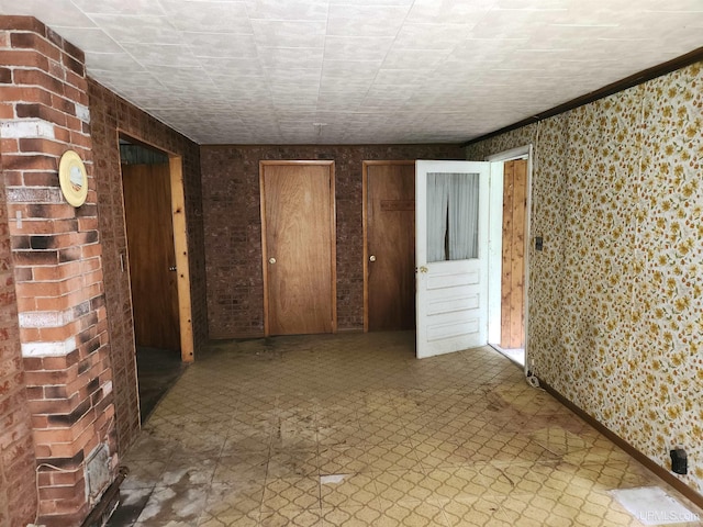 1120 Dextrom Rd, Calumet, MI 49913 - spare room featuring wallpapered walls and tile patterned floors