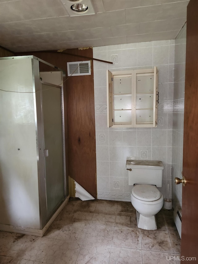 1120 Dextrom Rd, Calumet, MI 49913 - bathroom with a stall shower, a baseboard radiator, and tile walls