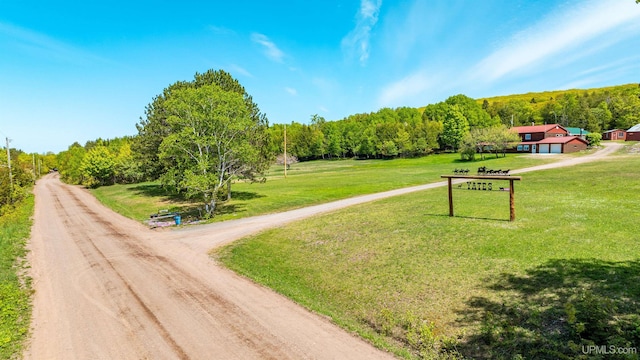 1120 Dextrom Rd, Calumet, MI 49913 - view of community with driveway, a view of trees, and a lawn