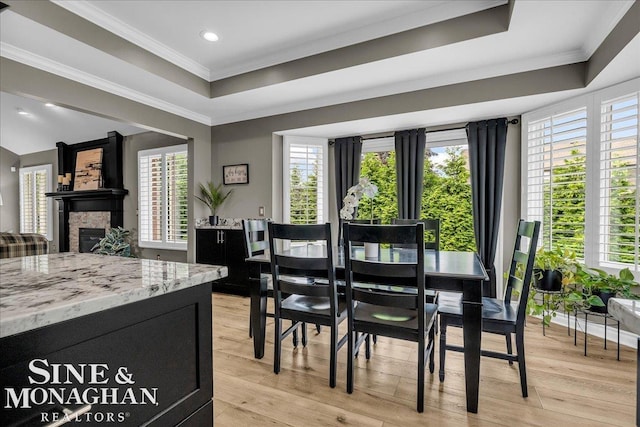 1319 S River Pointe Dr, Saint Clair, MI 48079 - dining room with a raised ceiling, healthy amount of natural light, a glass covered fireplace, light wood finished floors, and ornamental molding