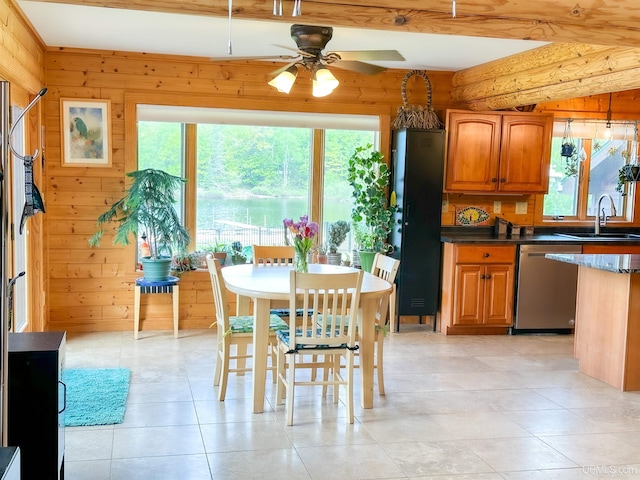 273 N Basin Dr, Negaunee, MI 49866 - dining space featuring a ceiling fan, wood walls, light tile patterned flooring, and beamed ceiling