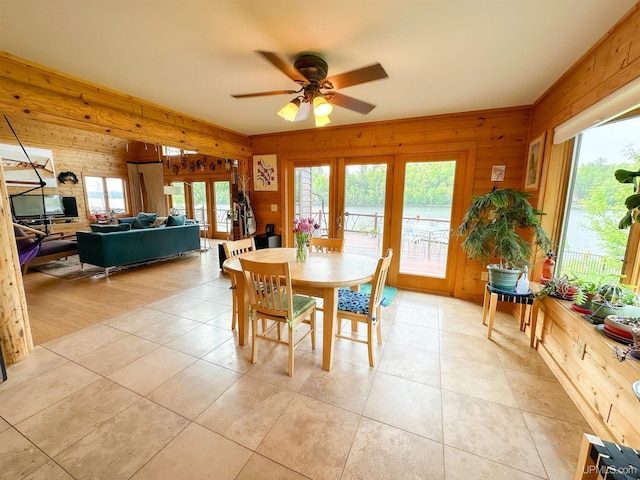 273 N Basin Dr, Negaunee, MI 49866 - dining room with french doors, wood walls, a ceiling fan, and light tile patterned floors