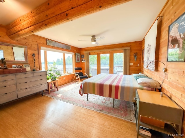 273 N Basin Dr, Negaunee, MI 49866 - bedroom featuring wood finished floors, access to exterior, wood walls, beamed ceiling, and french doors