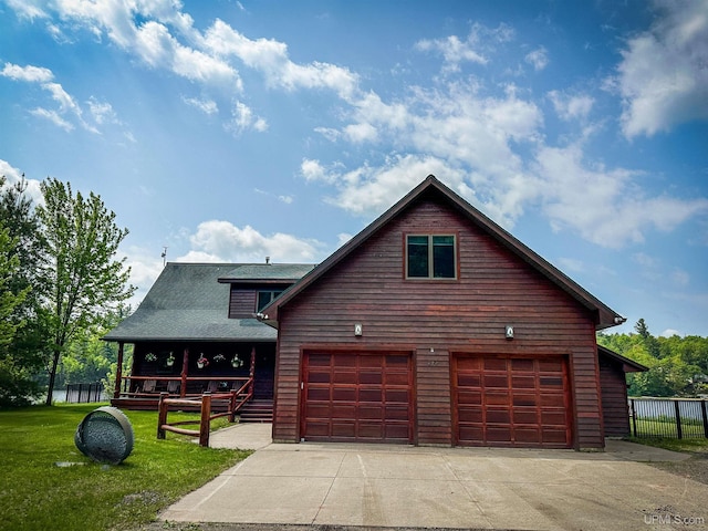 273 N Basin Dr, Negaunee, MI 49866 - chalet / cabin featuring a garage, concrete driveway, and roof with shingles
