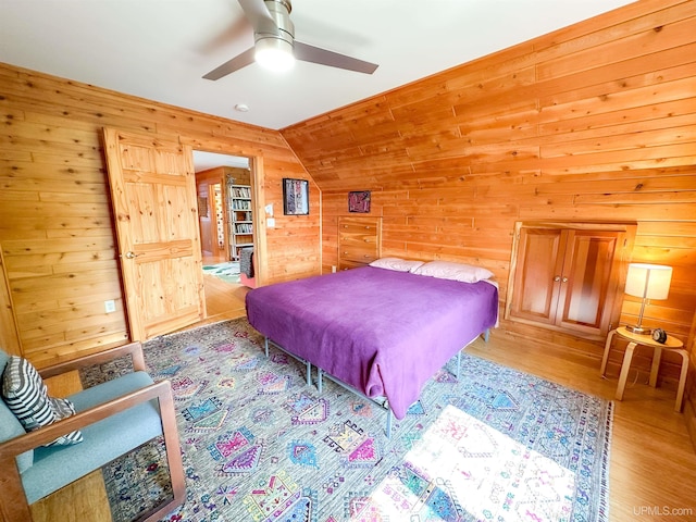 273 N Basin Dr, Negaunee, MI 49866 - bedroom featuring wooden walls, light wood-style flooring, lofted ceiling, and ceiling fan