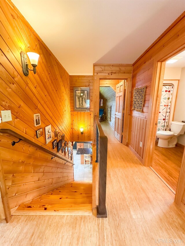 273 N Basin Dr, Negaunee, MI 49866 - staircase featuring wood finished floors and wooden walls