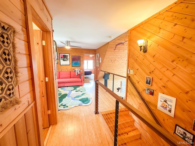 273 N Basin Dr, Negaunee, MI 49866 - hallway featuring wooden walls, an upstairs landing, and wood finished floors