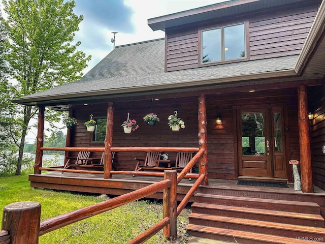 273 N Basin Dr, Negaunee, MI 49866 - property entrance featuring a porch and roof with shingles