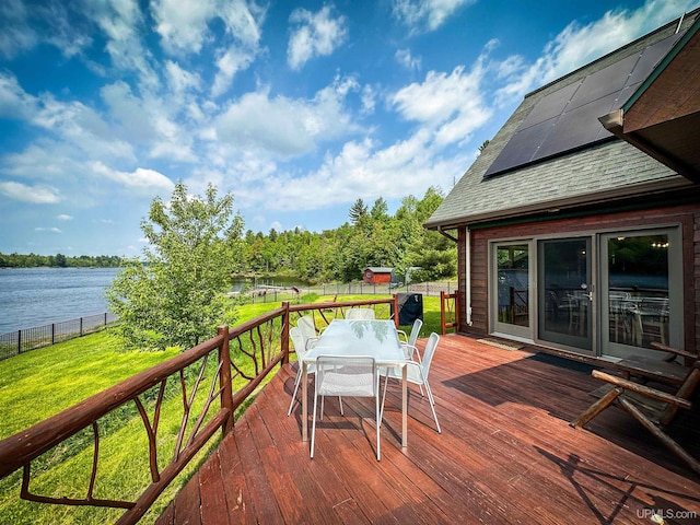273 N Basin Dr, Negaunee, MI 49866 - wooden deck with outdoor dining area, a water view, and a fenced backyard