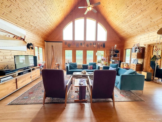 273 N Basin Dr, Negaunee, MI 49866 - living room featuring high vaulted ceiling, wooden walls, ceiling fan, light wood-style flooring, and wood ceiling